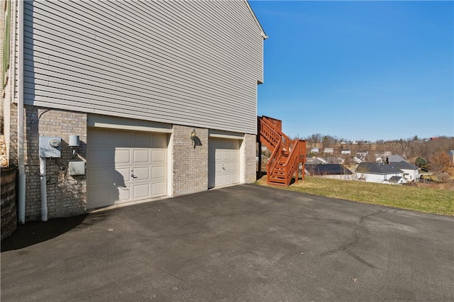 garage with aphalt driveway