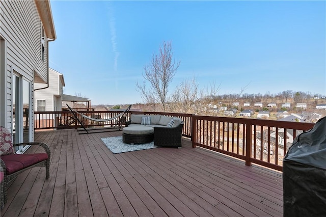 wooden terrace featuring grilling area and an outdoor hangout area