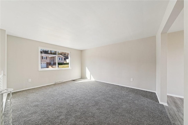 carpeted empty room with visible vents and baseboards