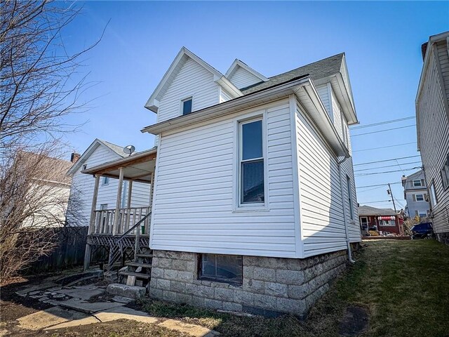 view of side of home with a yard