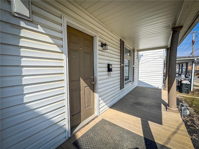 view of exterior entry featuring covered porch