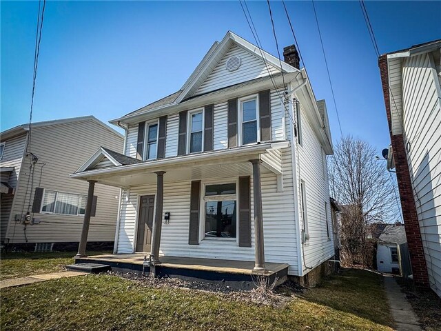 view of front of property with a porch and a chimney