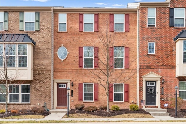 townhome / multi-family property with brick siding