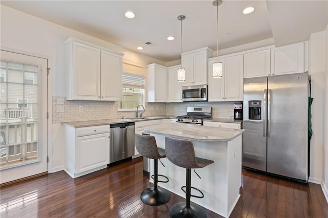 kitchen with a sink, visible vents, appliances with stainless steel finishes, and white cabinets