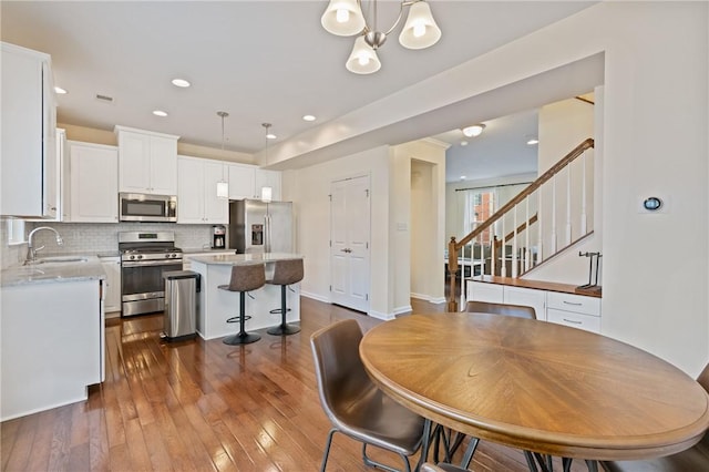 dining area with visible vents, dark wood-style flooring, recessed lighting, baseboards, and stairs