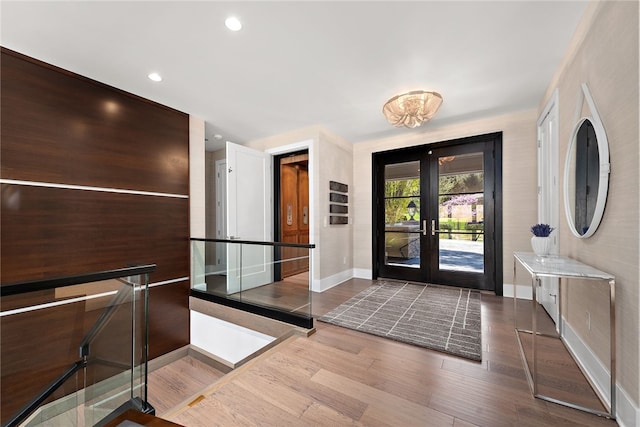 entryway featuring recessed lighting, wood finished floors, baseboards, and french doors