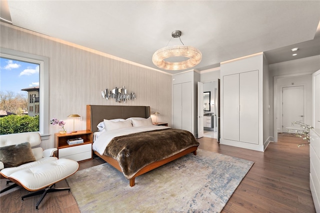 bedroom featuring two closets and wood finished floors