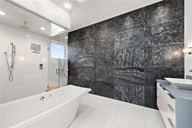 bathroom with tile patterned floors, a soaking tub, tile walls, and a stall shower