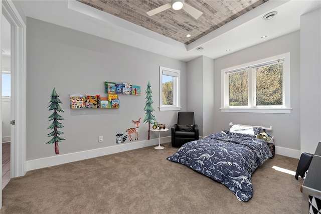 carpeted bedroom with visible vents, baseboards, recessed lighting, wooden ceiling, and a raised ceiling