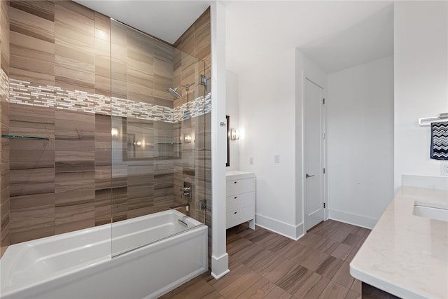 full bathroom with vanity, baseboards, and bath / shower combo with glass door