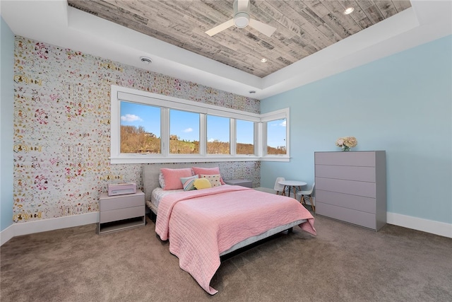 bedroom with carpet, a raised ceiling, wood ceiling, and baseboards