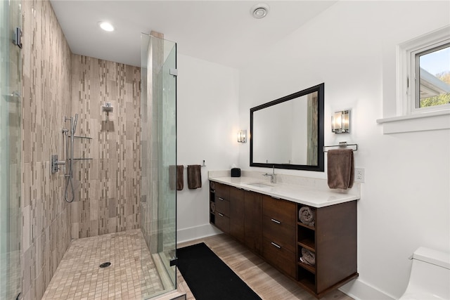 full bath with vanity, toilet, and a stall shower