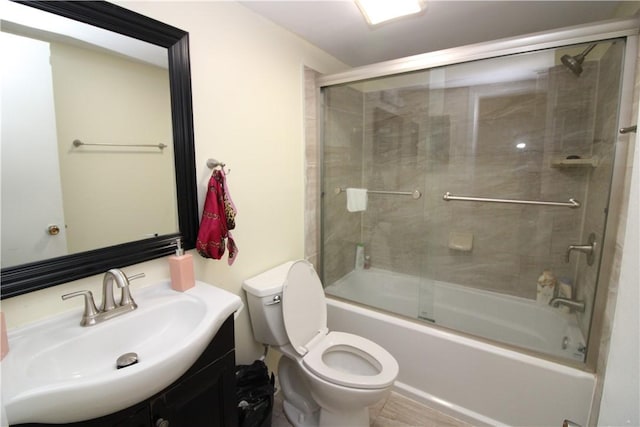 bathroom featuring vanity, toilet, and enclosed tub / shower combo