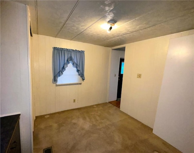 unfurnished room featuring visible vents and carpet floors