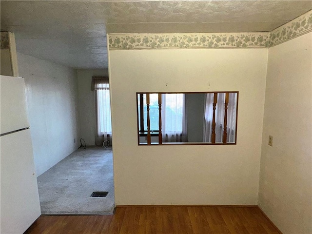 empty room with visible vents and wood finished floors