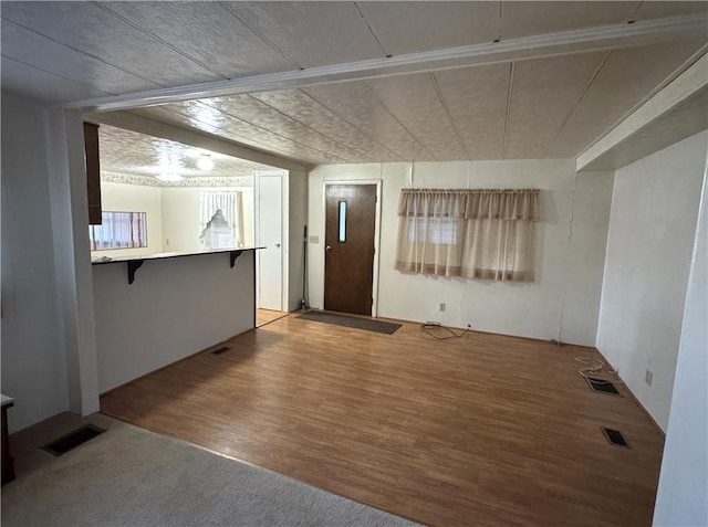 unfurnished room featuring wood finished floors and visible vents