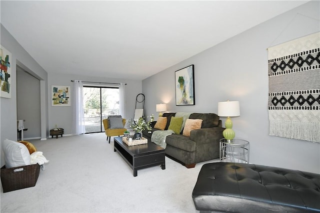 living area featuring carpet flooring and baseboards