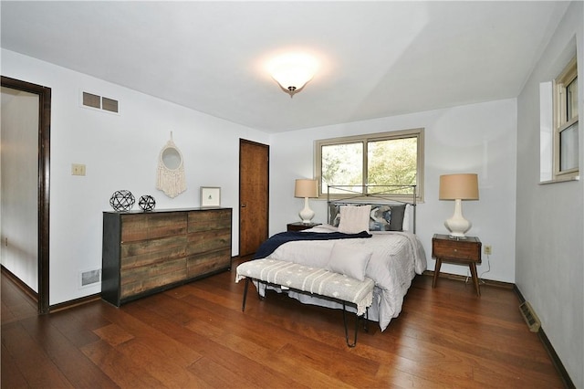 bedroom with hardwood / wood-style floors and visible vents