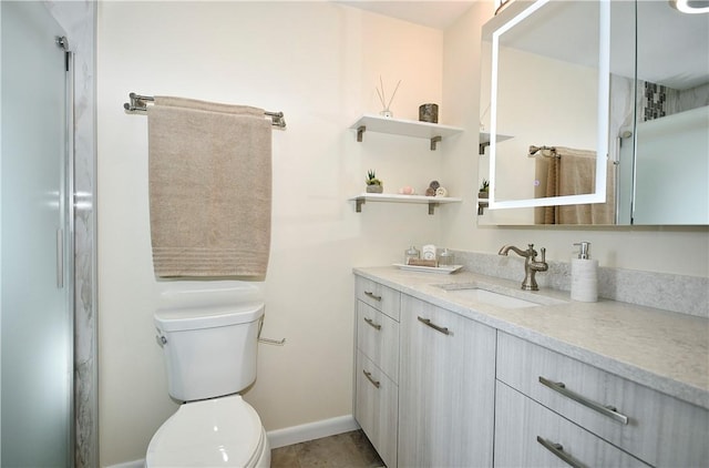 bathroom featuring vanity, tile patterned floors, toilet, and baseboards