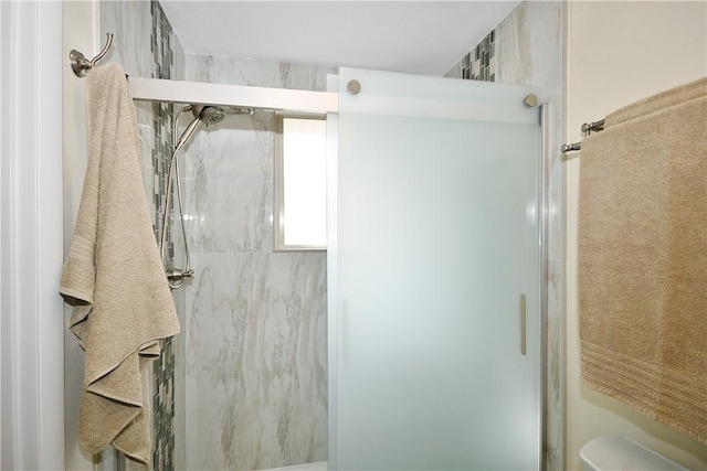 full bathroom with a shower stall and toilet