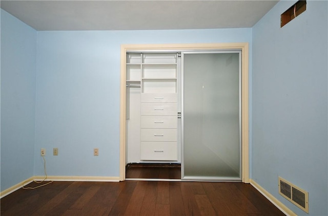 unfurnished bedroom with visible vents, baseboards, and hardwood / wood-style floors