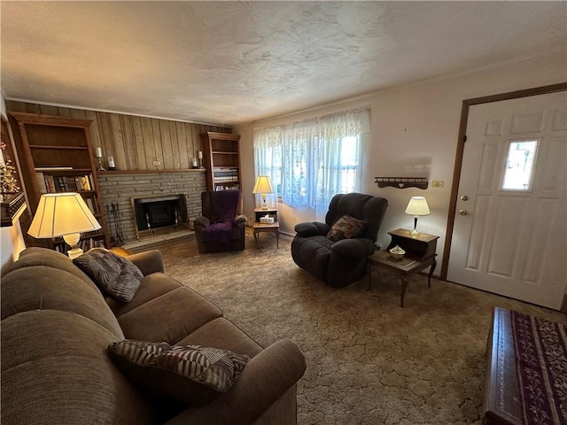 carpeted living area with built in features, a fireplace, and a textured ceiling