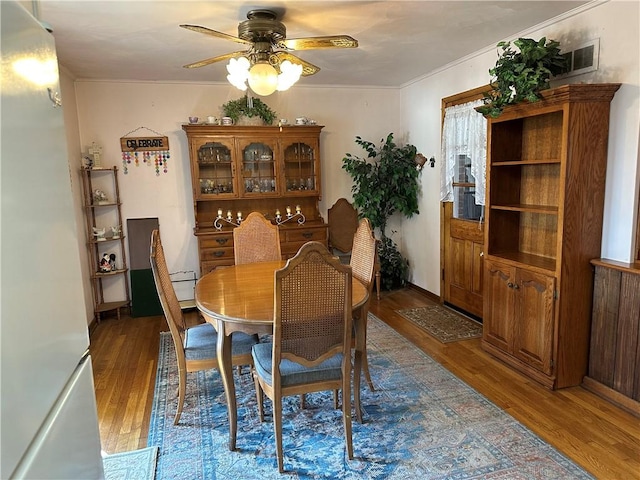 dining space featuring ceiling fan and wood finished floors