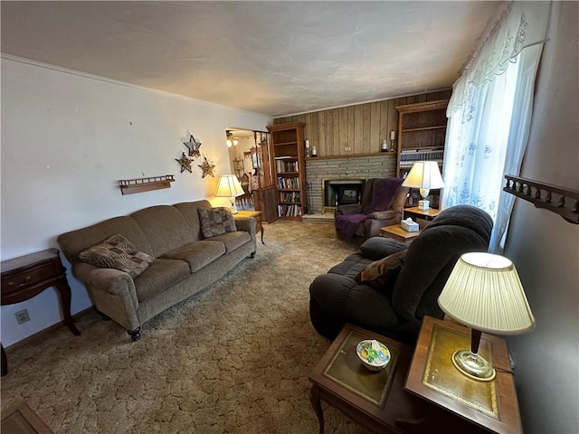 living area featuring a fireplace, a ceiling fan, and carpet floors