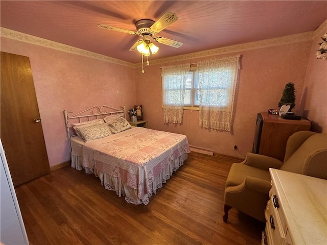 bedroom featuring wood finished floors, baseboards, baseboard heating, and ceiling fan