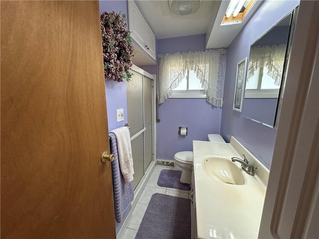 full bathroom with vanity, toilet, a shower stall, and tile patterned flooring