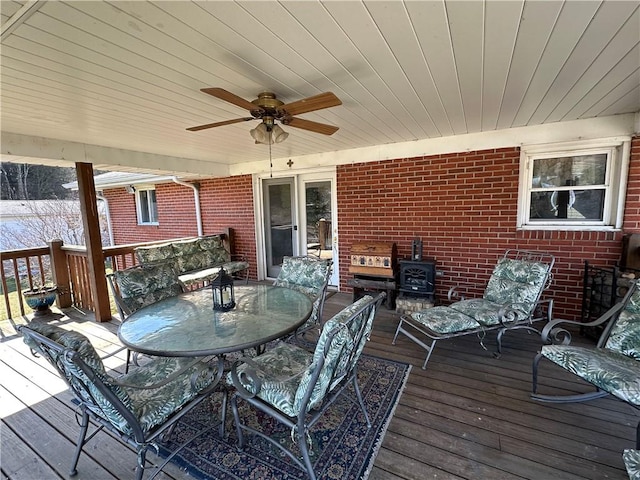 deck featuring outdoor dining space and ceiling fan