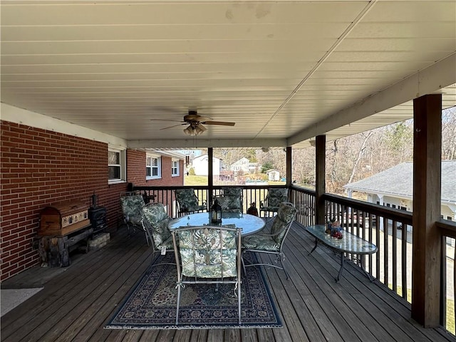 deck featuring outdoor dining space and a ceiling fan