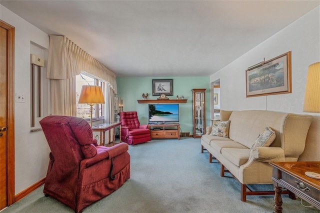 carpeted living area with baseboards