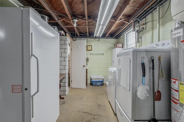 clothes washing area featuring laundry area, gas water heater, and separate washer and dryer