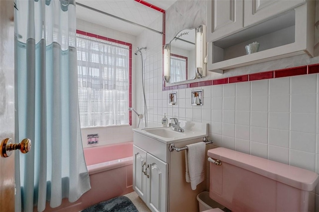 full bathroom with plenty of natural light, toilet, tile walls, and shower / tub combo