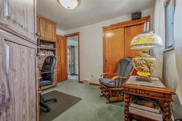 carpeted home office featuring visible vents and baseboards