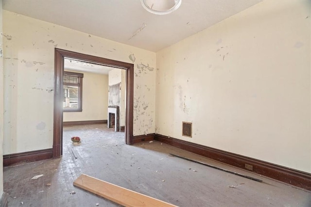 unfurnished room with visible vents and baseboards