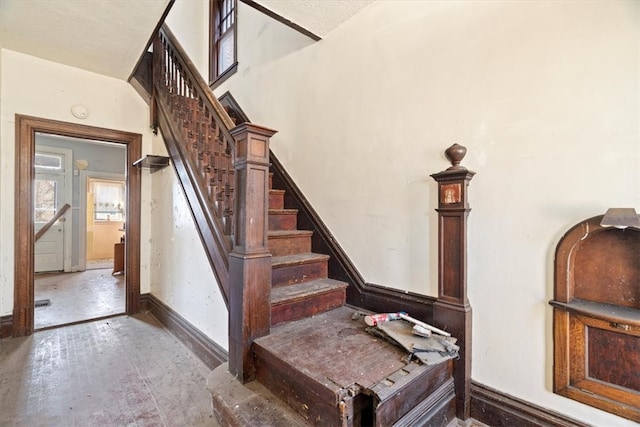 staircase featuring baseboards