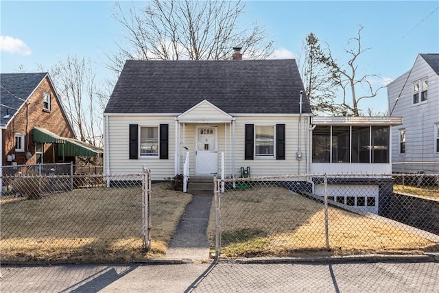 cape cod house with a front lawn, a sunroom, a fenced front yard, and a chimney