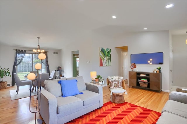 living room with recessed lighting, light wood-style floors, visible vents, and a chandelier