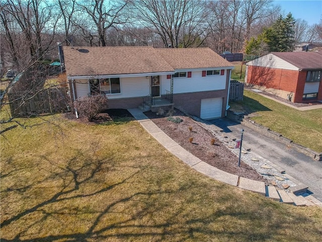 ranch-style house featuring aphalt driveway, an attached garage, a shingled roof, and a front lawn