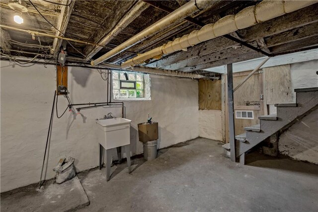 basement featuring visible vents and stairs