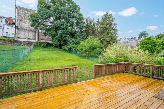 deck featuring a yard and fence