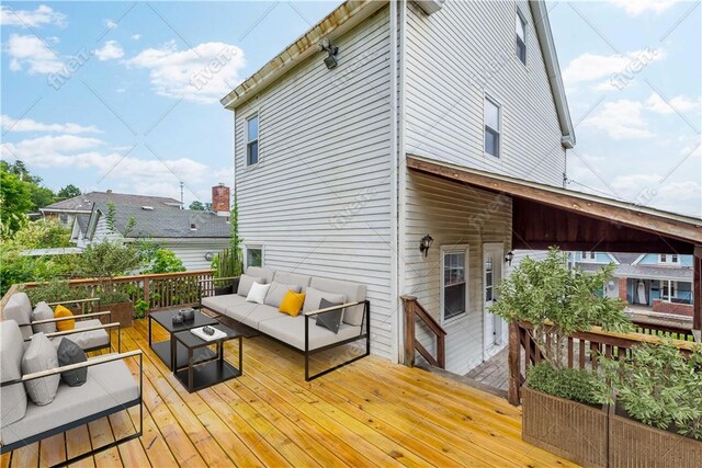 wooden terrace with an outdoor hangout area