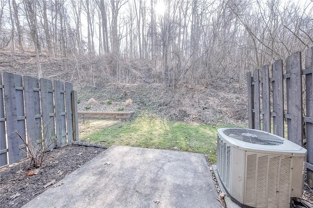 view of yard with fence and central AC