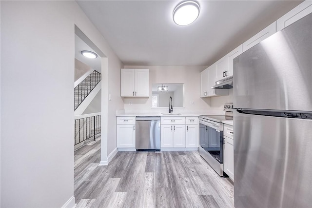 kitchen featuring a sink, light countertops, white cabinets, and stainless steel appliances