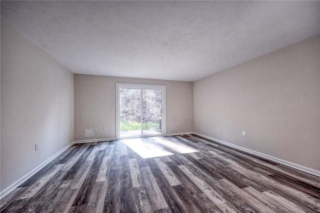 unfurnished room featuring baseboards, a textured ceiling, and dark wood-style floors