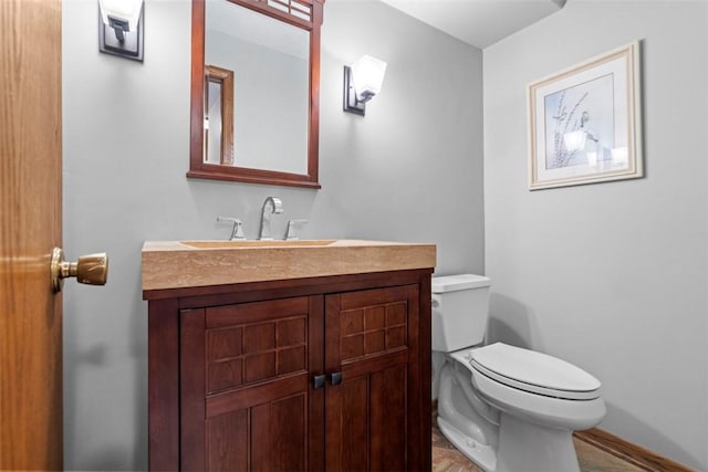 half bath featuring toilet and vanity