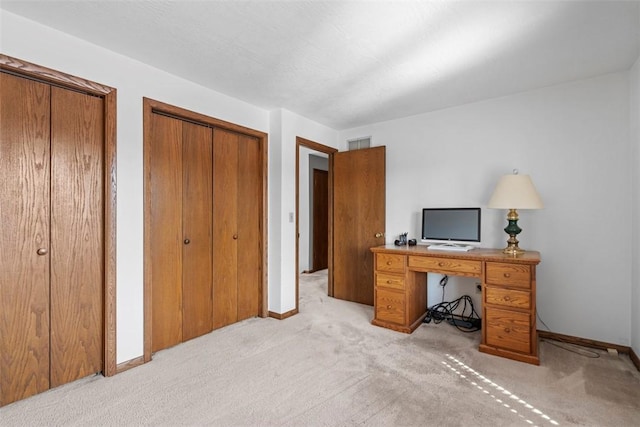 office space featuring visible vents, light colored carpet, and baseboards