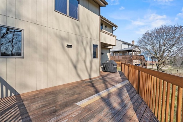 wooden deck with a grill